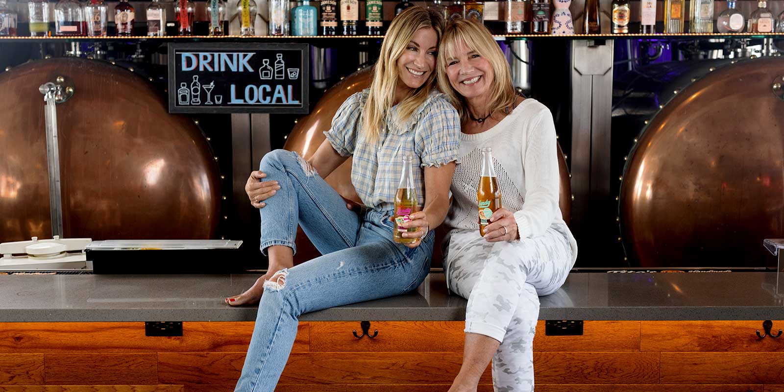 Sandy and Kelly Furano holding beers