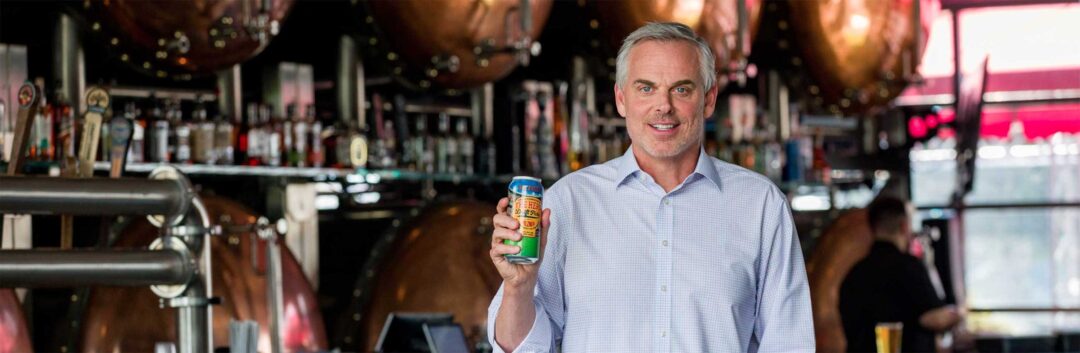 Colin Cowherd holding one of his Draft Picks beers