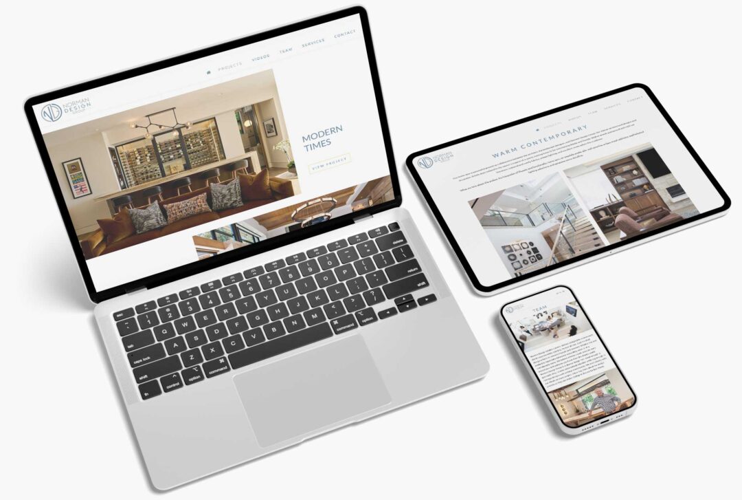 Various pages of the Norman Design Group responsive website shown on a laptop, tablet, and phone